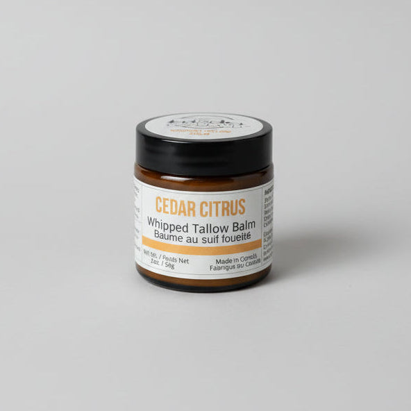 Jar of Cedar Citrus whipped talcum balm with neutral studio background