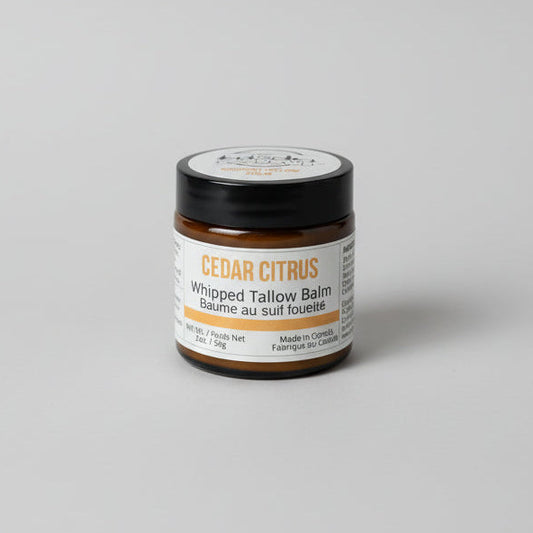 Jar of Cedar Citrus whipped talcum balm with neutral studio background